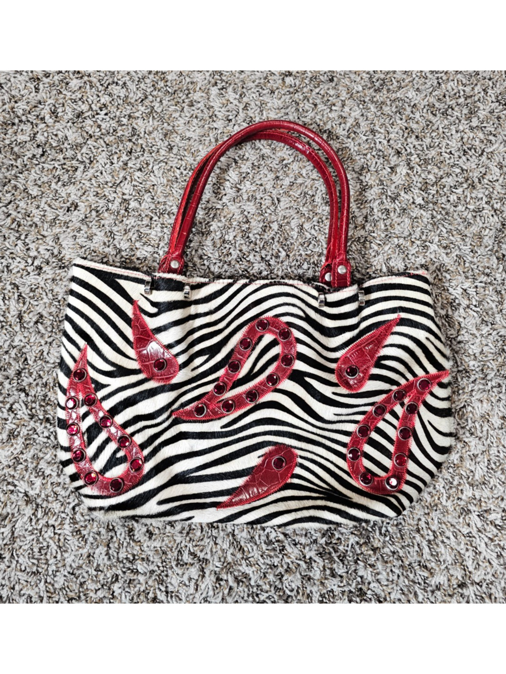 Cecconi Piero zebra print tote featuring red leather embellishments